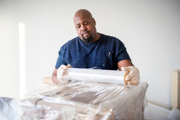 black-man-moving-furniture_53876-20674