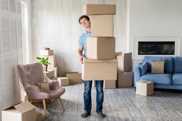 front-view-man-holding-lots-boxes-moving-out_23-2148647535